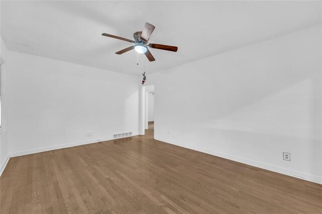 spare room with ceiling fan and hardwood / wood-style flooring