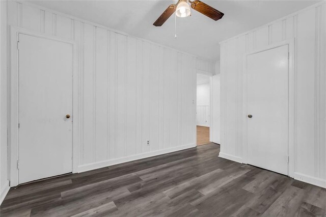 unfurnished bedroom featuring ceiling fan and dark wood-type flooring