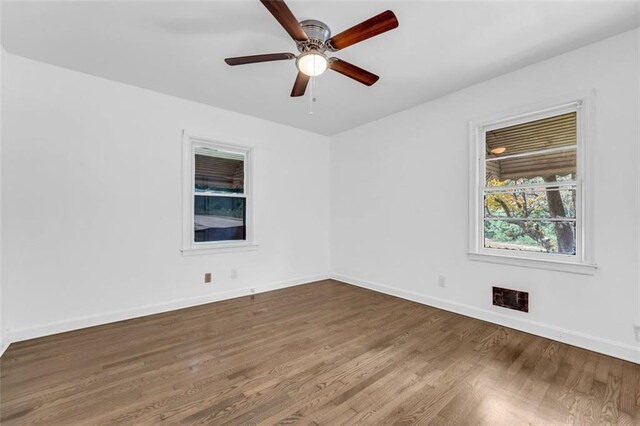 unfurnished room with hardwood / wood-style floors and ceiling fan