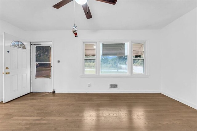 unfurnished room with hardwood / wood-style flooring and ceiling fan