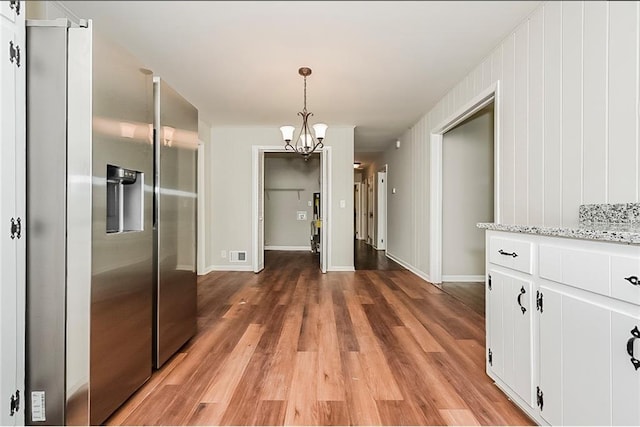 unfurnished dining area with dark hardwood / wood-style flooring and a notable chandelier