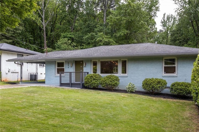 ranch-style home featuring a front yard, a porch, driveway, and brick siding