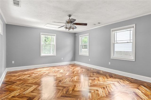 empty room featuring visible vents, a textured ceiling, and a healthy amount of sunlight