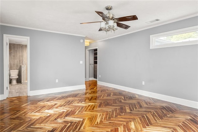 empty room with baseboards, a ceiling fan, and visible vents
