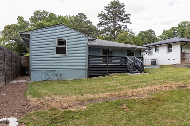 back of property featuring fence, a yard, and cooling unit