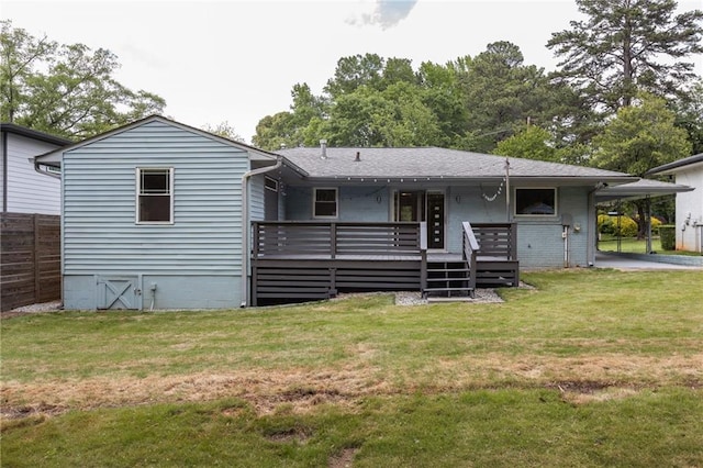 rear view of house featuring fence, a yard, and a deck