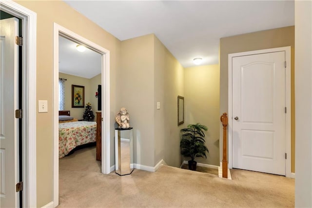 corridor featuring light colored carpet