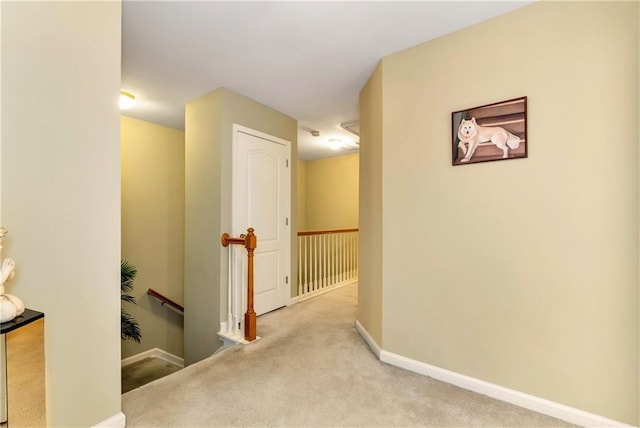 hallway featuring light colored carpet