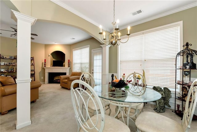 carpeted dining area featuring ceiling fan with notable chandelier and ornamental molding