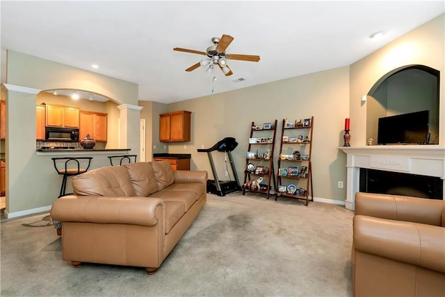 carpeted living room featuring ceiling fan