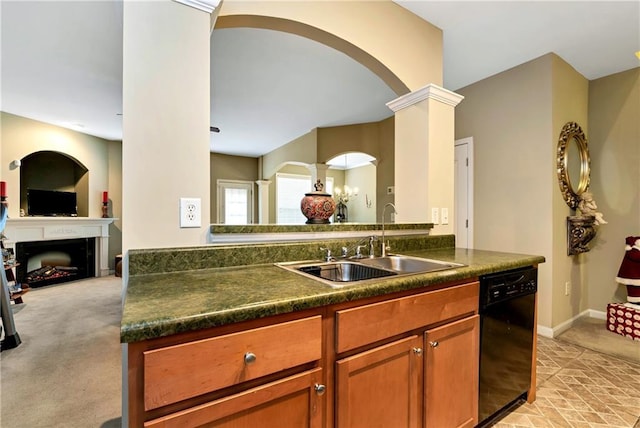 kitchen with sink, black dishwasher, light carpet, and decorative columns