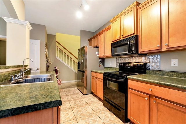 kitchen with sink, backsplash, rail lighting, and black appliances