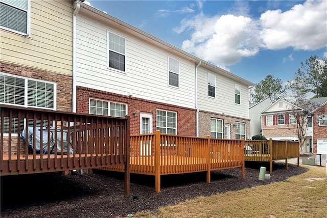 back of house featuring a wooden deck