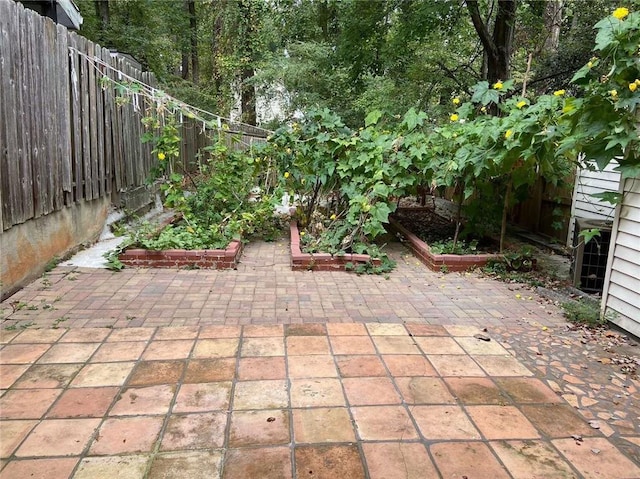 view of patio / terrace featuring a fenced backyard and a garden