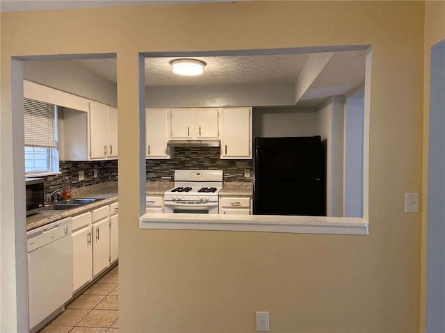 kitchen with tasteful backsplash, white appliances, light tile patterned floors, white cabinets, and under cabinet range hood