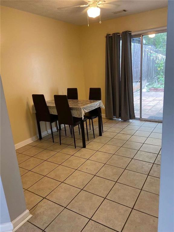 dining room featuring visible vents, baseboards, light tile patterned flooring, and ceiling fan