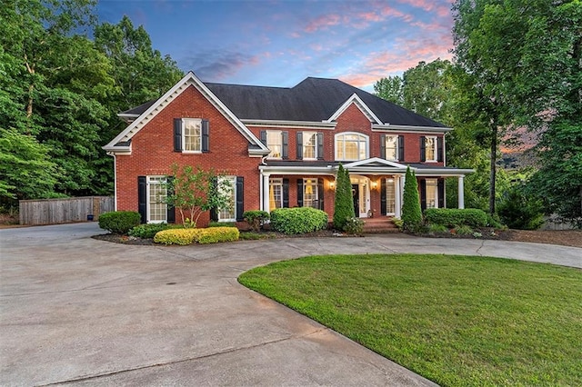 colonial home featuring a lawn