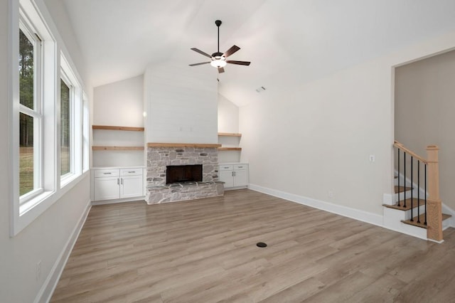 130 Doris Path, Dallas, GA 30157 - unfurnished living room featuring light wood finished floors, a ceiling fan, a fireplace, stairs, and high vaulted ceiling