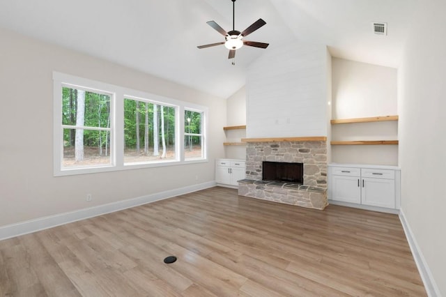 130 Doris Path, Dallas, GA 30157 - unfurnished living room with ceiling fan, a stone fireplace, light wood finished floors, baseboards, and high vaulted ceiling