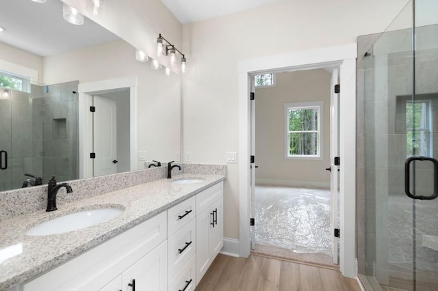 130 Doris Path, Dallas, GA 30157 - full bathroom with plenty of natural light, a stall shower, wood finished floors, and double vanity