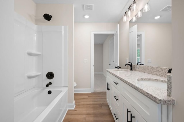 130 Doris Path, Dallas, GA 30157 - bathroom featuring double vanity, washtub / shower combination, baseboards, wood finished floors, and recessed lighting