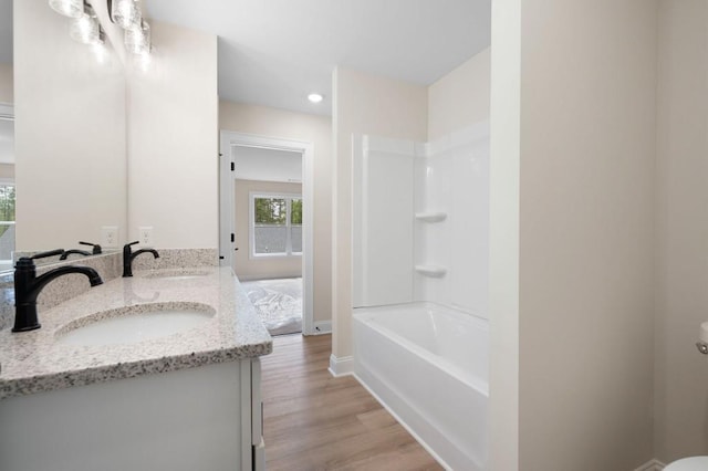 130 Doris Path, Dallas, GA 30157 - bathroom with wood finished floors, double vanity, baseboards, recessed lighting, and shower / tub combination