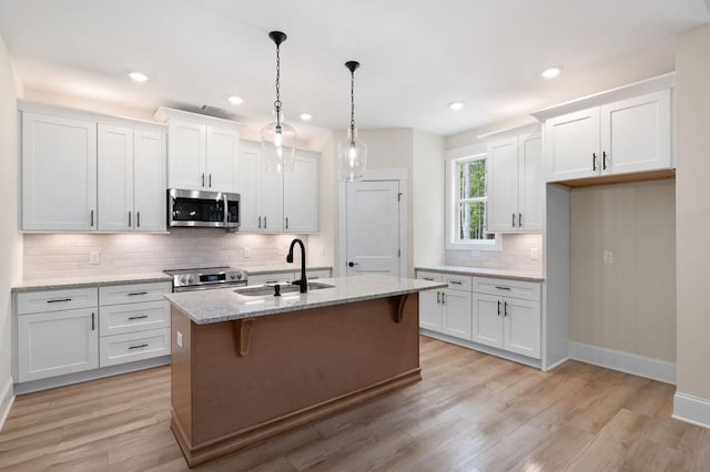 130 Doris Path, Dallas, GA 30157 - kitchen featuring stainless steel appliances, a sink, decorative backsplash, white cabinets, and baseboards