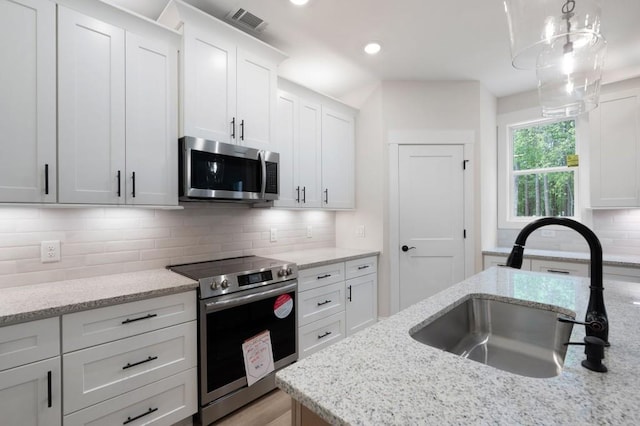 130 Doris Path, Dallas, GA 30157 - kitchen featuring appliances with stainless steel finishes, a sink, white cabinetry, decorative backsplash, and recessed lighting