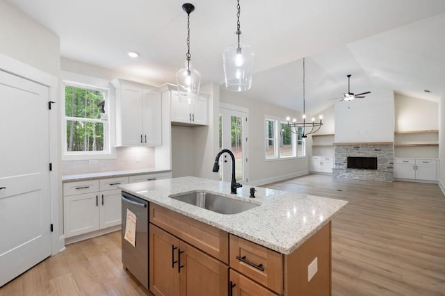 130 Doris Path, Dallas, GA 30157 - kitchen featuring a sink, stainless steel dishwasher, light wood finished floors, a stone fireplace, and lofted ceiling