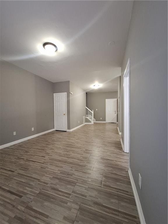 empty room with dark wood-type flooring