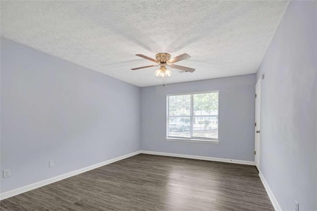 unfurnished room featuring dark wood finished floors, baseboards, ceiling fan, and a textured ceiling