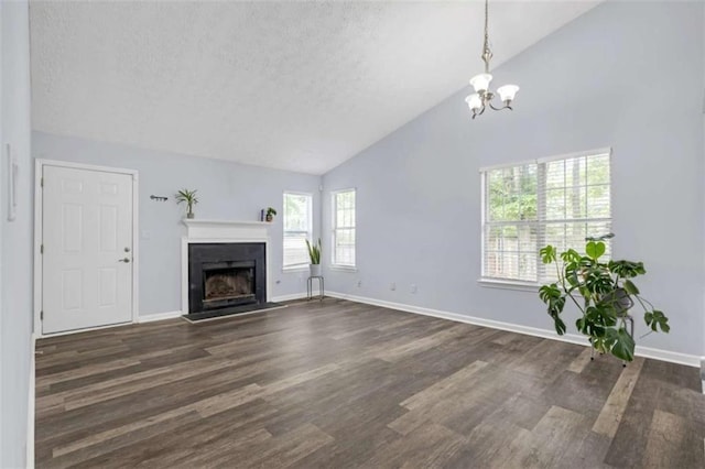 unfurnished living room featuring a textured ceiling, a chandelier, dark wood-style floors, baseboards, and a fireplace with flush hearth