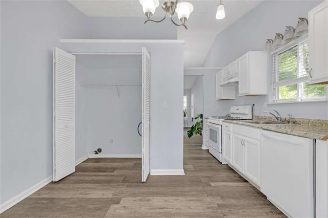kitchen featuring a sink, white cabinetry, white appliances, and a notable chandelier