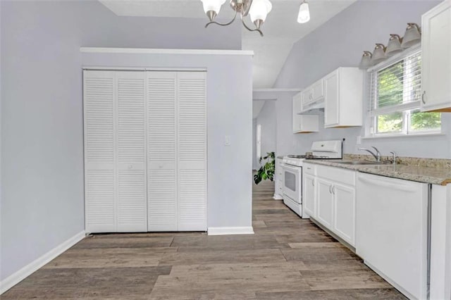 kitchen with under cabinet range hood, white appliances, a sink, a chandelier, and white cabinets