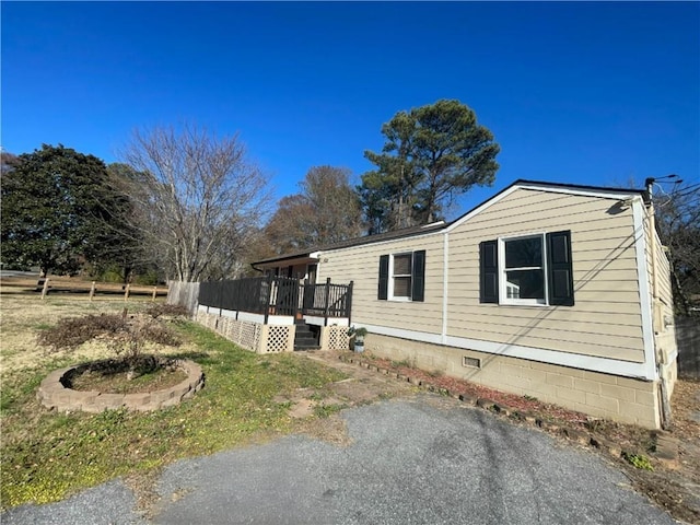 view of side of home with a deck