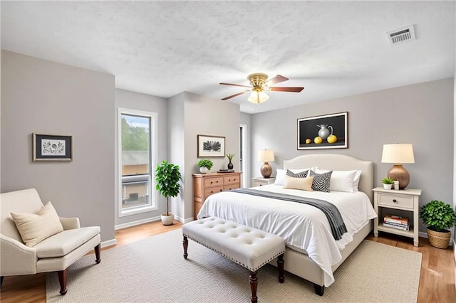 2340 Beaver Ruin Rd Unit 68, Norcross, GA 30071 - bedroom with wood finished floors, ceiling fan, and baseboards