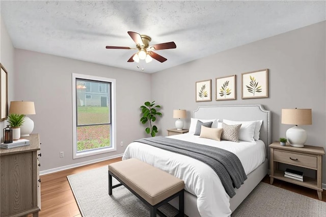 2340 Beaver Ruin Rd Unit 68, Norcross, GA 30071 - bedroom featuring light wood-style flooring, baseboards, and ceiling fan
