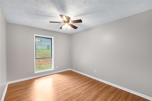 2340 Beaver Ruin Rd Unit 68, Norcross, GA 30071 - empty room featuring light wood finished floors, baseboards, a textured ceiling, and a ceiling fan