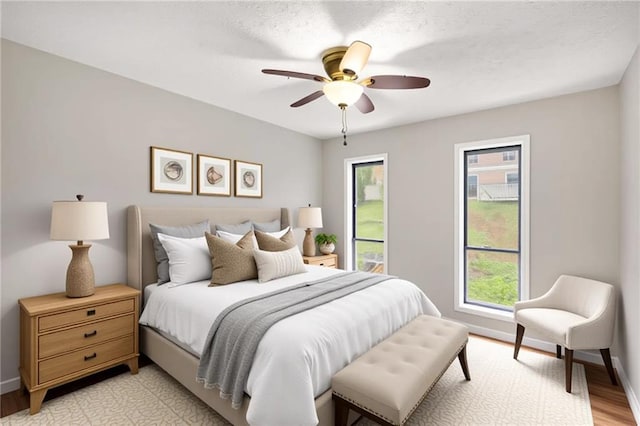 2340 Beaver Ruin Rd Unit 68, Norcross, GA 30071 - bedroom with light wood-style floors, baseboards, and ceiling fan