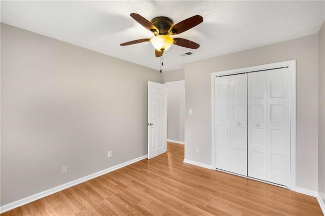 2340 Beaver Ruin Rd Unit 68, Norcross, GA 30071 - unfurnished bedroom with baseboards, light wood-type flooring, and a closet