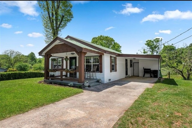 view of front of property with a front yard, covered porch, and a carport