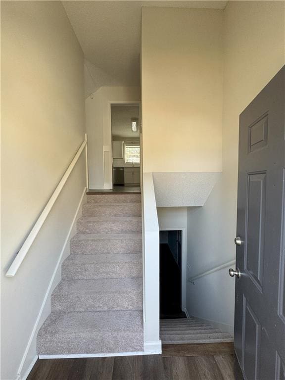 stairs featuring baseboards and wood finished floors