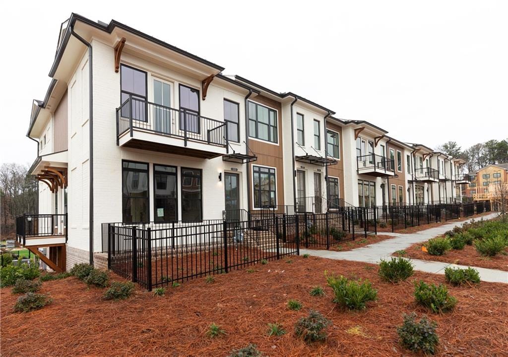 view of front of home with fence and a residential view