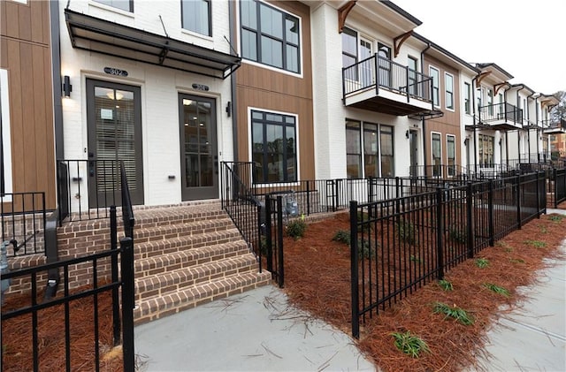 view of exterior entry featuring a balcony