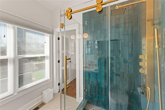 bathroom featuring a shower stall, visible vents, baseboards, and tile patterned floors