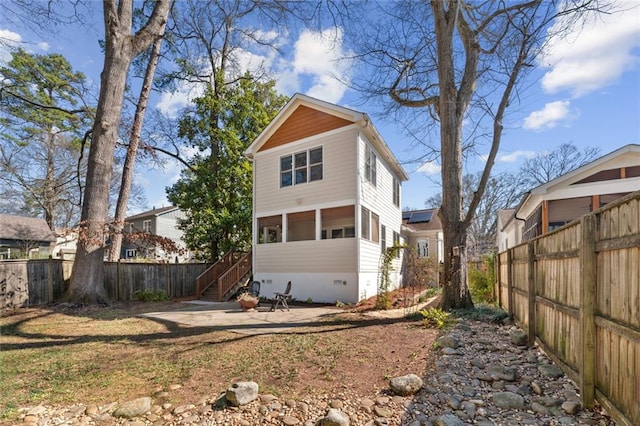 rear view of house featuring a sunroom, fence, and crawl space