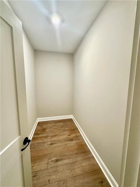 interior space with dark wood-type flooring and baseboards