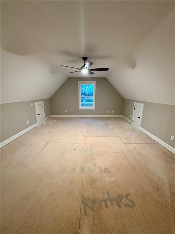 additional living space featuring vaulted ceiling, a ceiling fan, and baseboards