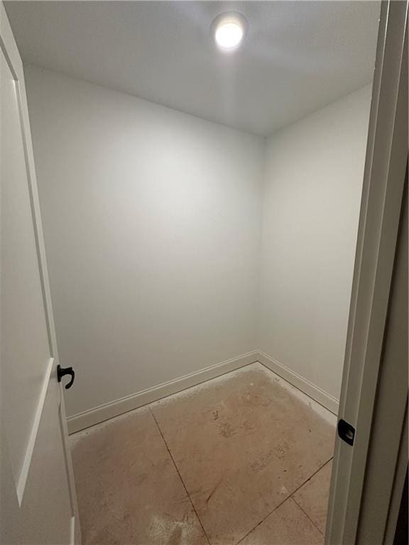 spare room with baseboards