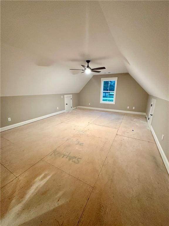 additional living space featuring ceiling fan, lofted ceiling, baseboards, and a textured ceiling